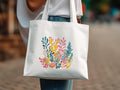 White tote bag with a colorful coral reef illustration.