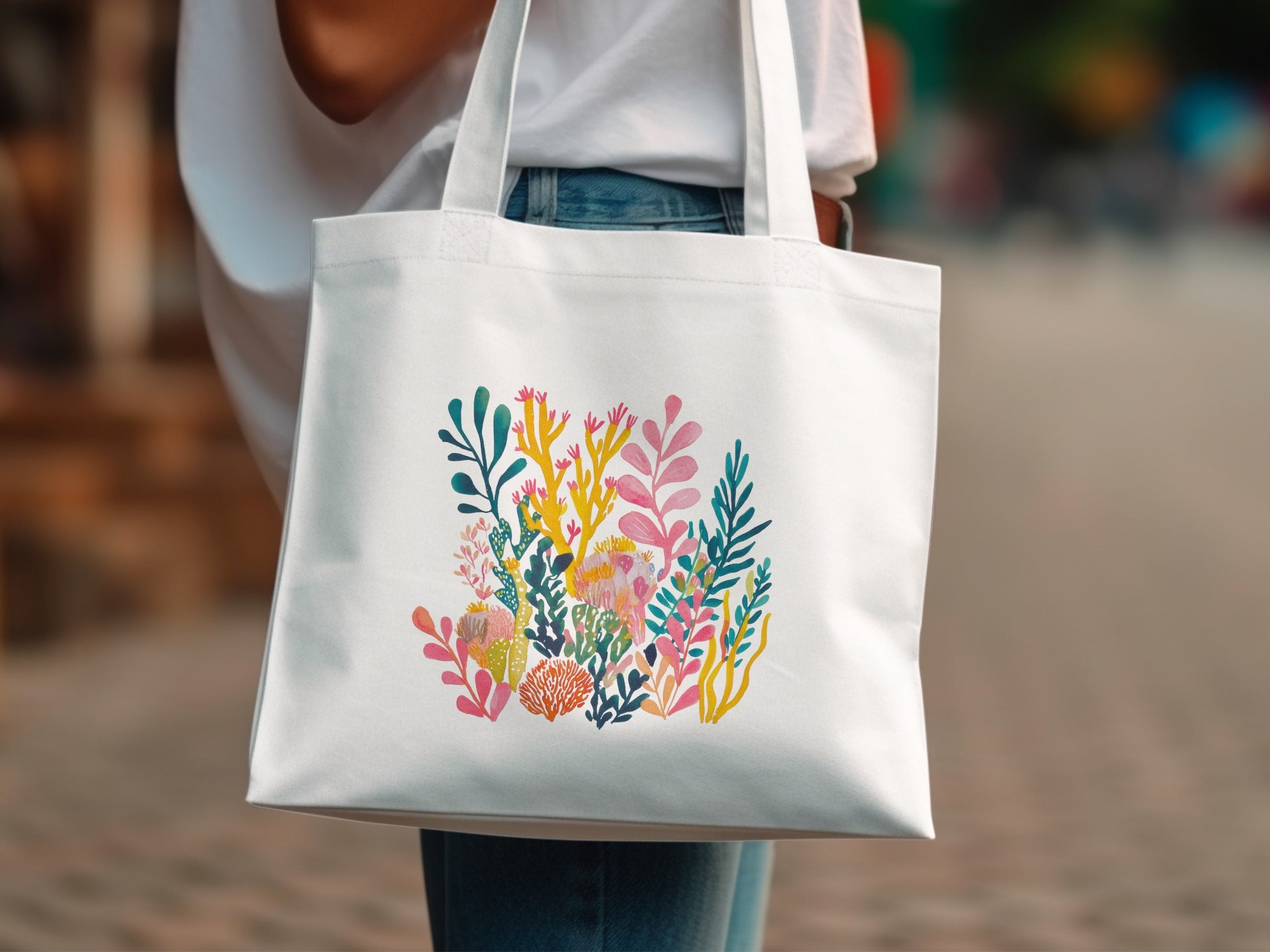 White tote bag with a colorful coral reef illustration.
