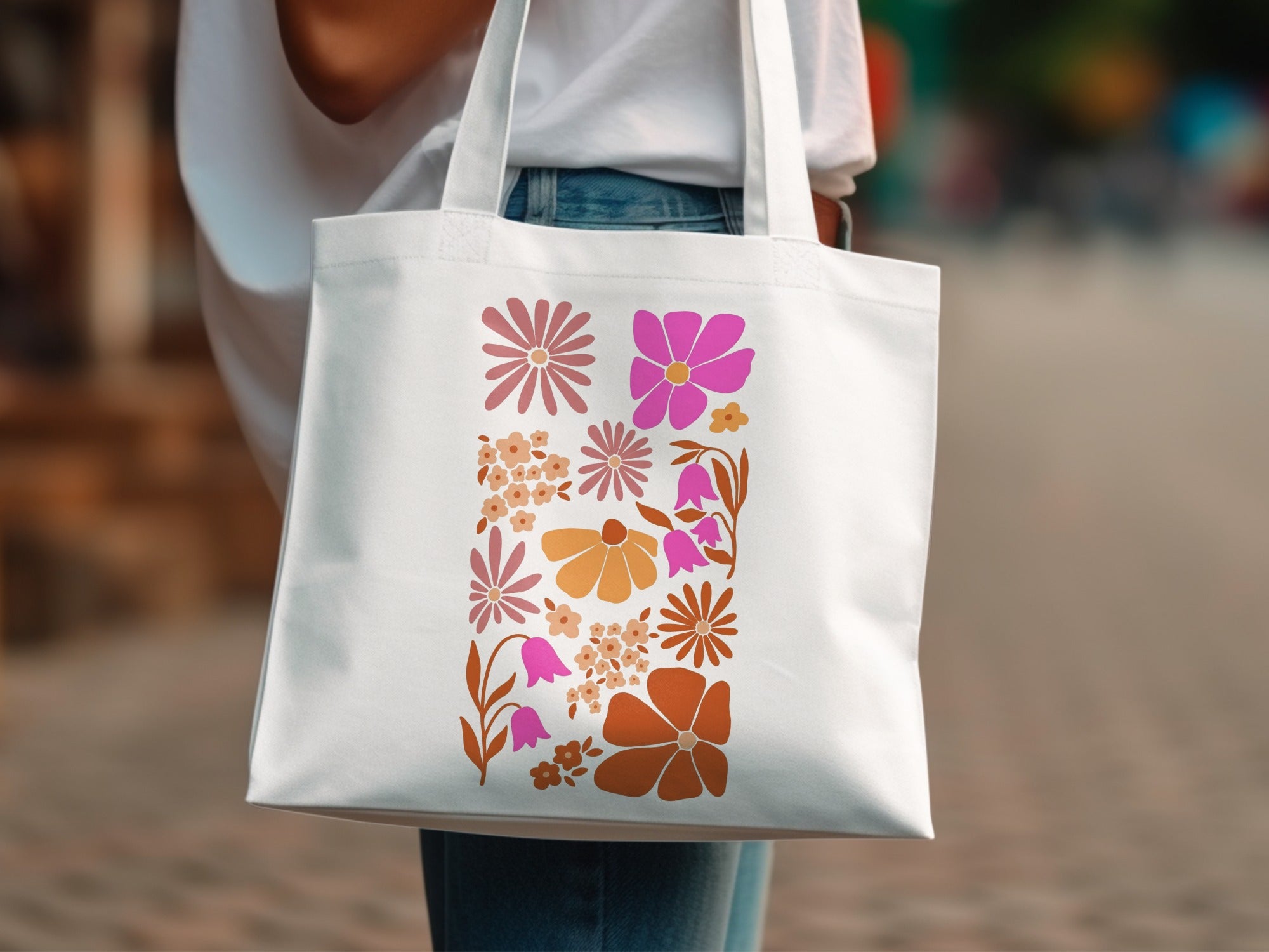 White tote bag with a colorful floral pattern in pink and orange.