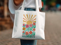 White canvas tote bag with colorful floral sunburst graphic design.