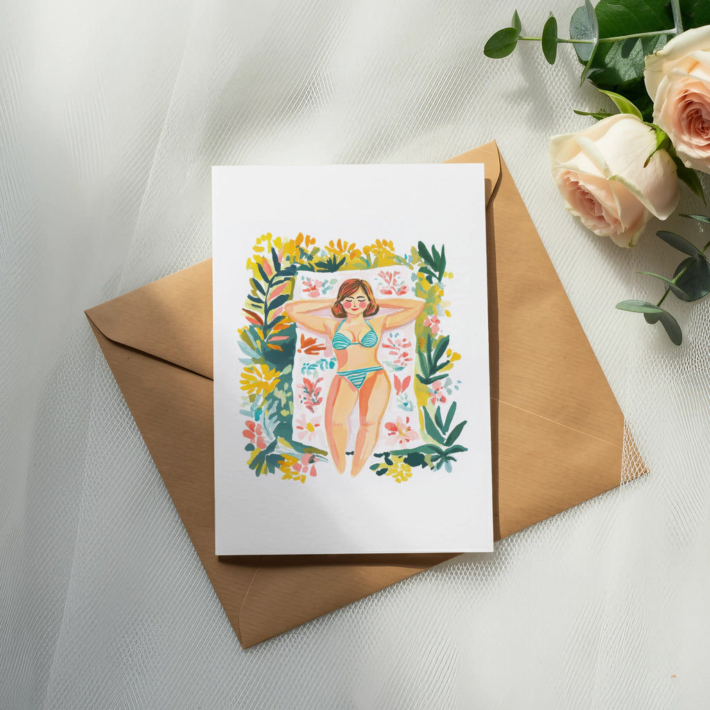 Card featuring a woman sunbathing on a towel surrounded by flowers.