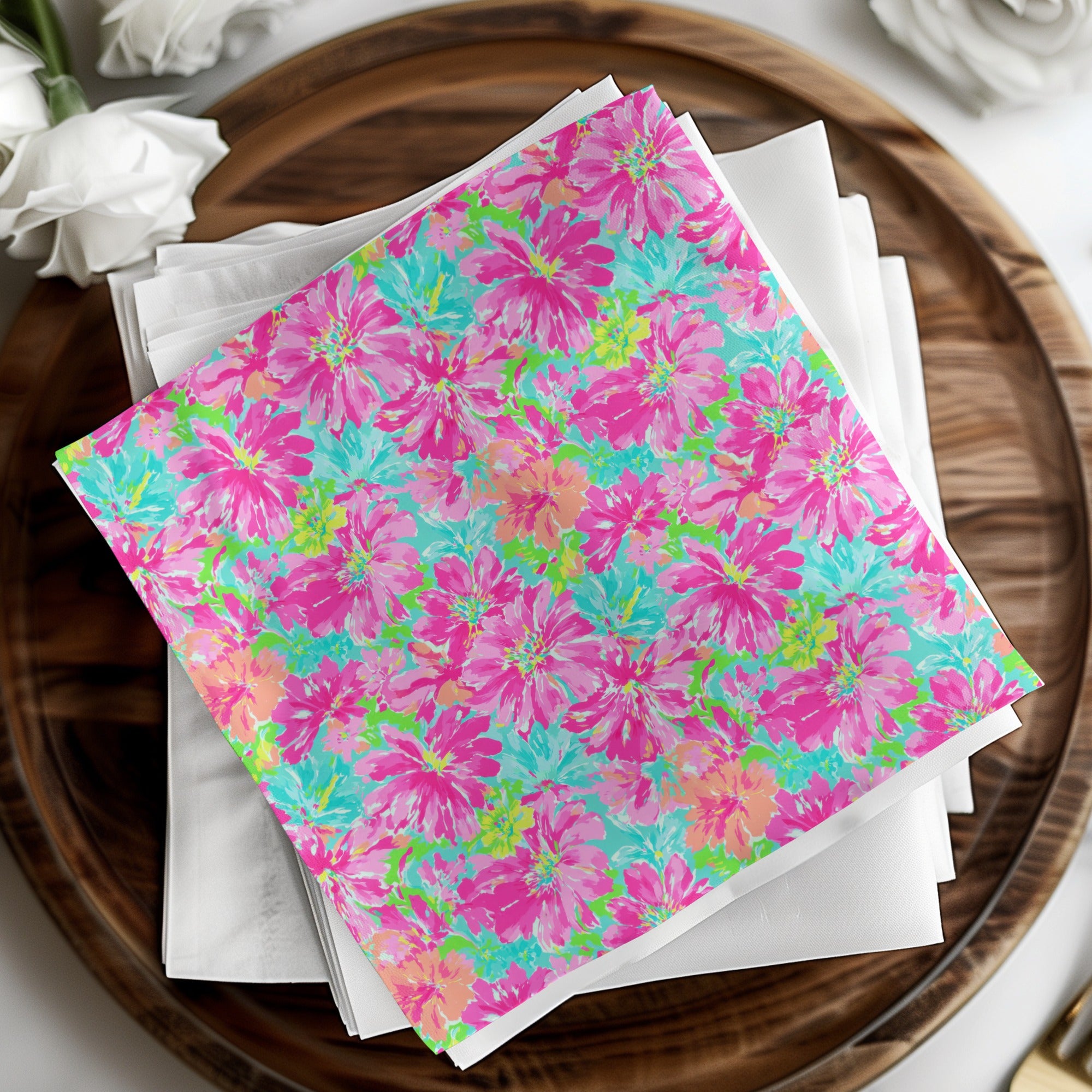 Stack of white napkins with a bright floral pattern.