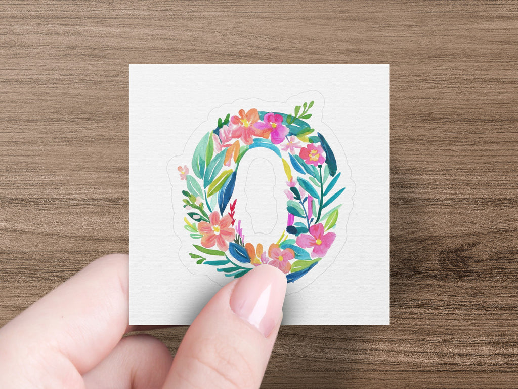 Floral letter O sticker with leaves and flowers on a white background.