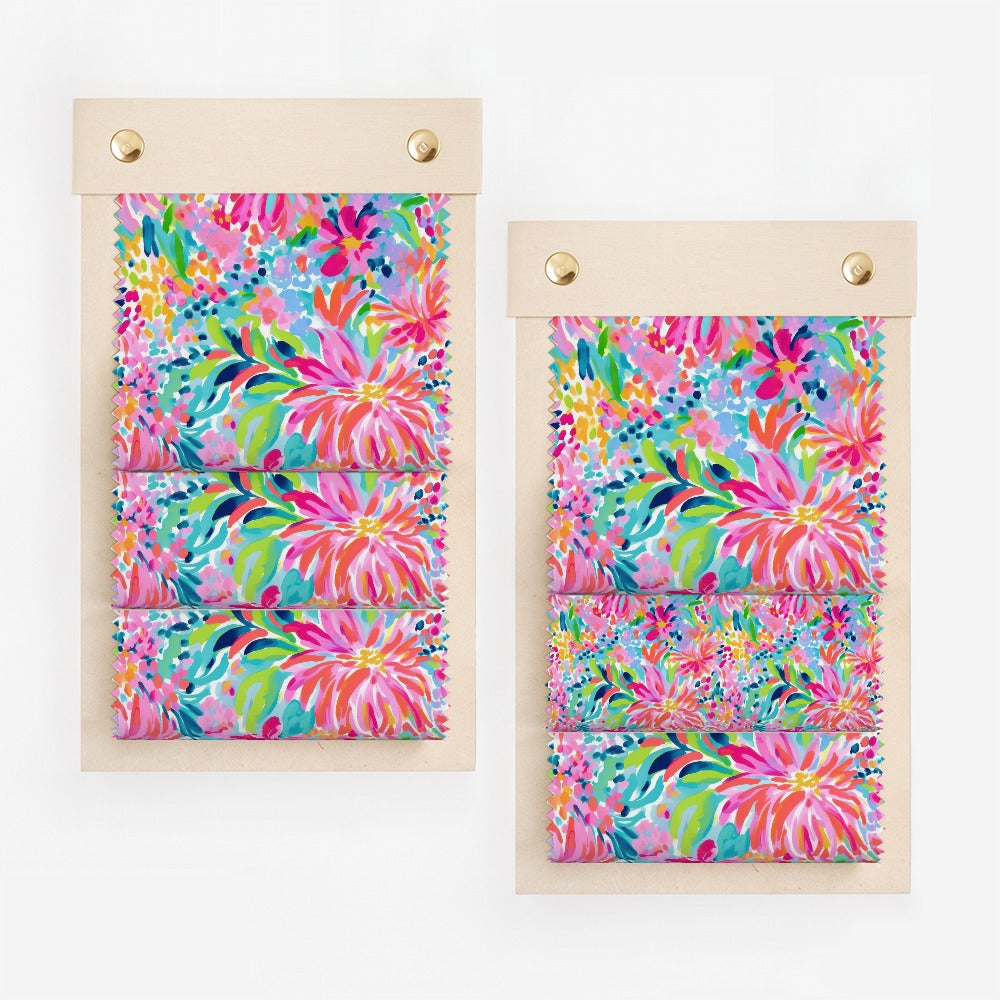 Colorful floral fabric swatches on wooden display boards.