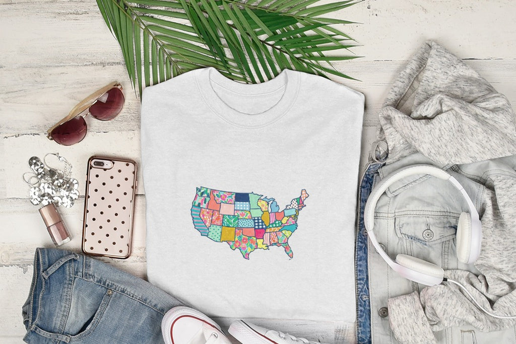 White t-shirt with a colorful patchwork map of the United States.