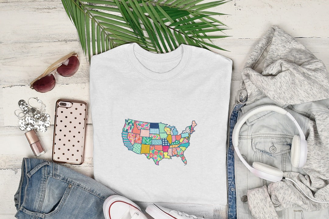 White t-shirt with a colorful patchwork map of the United States.