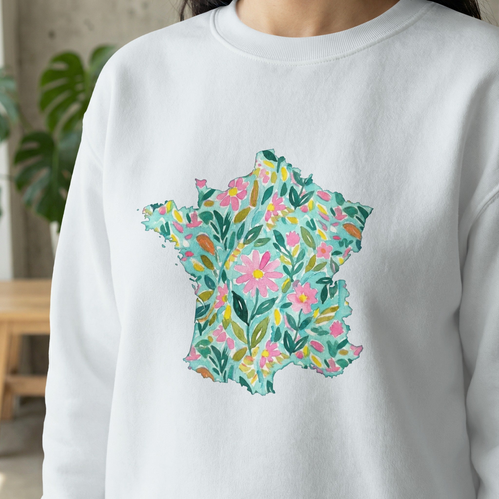 White sweatshirt with a watercolor floral map of France.