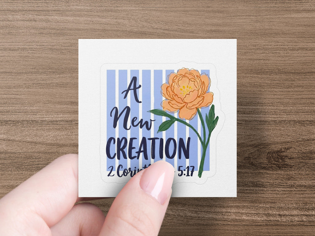 Square sticker with "A New Creation" and flower, 2 Corinthians 5:17.