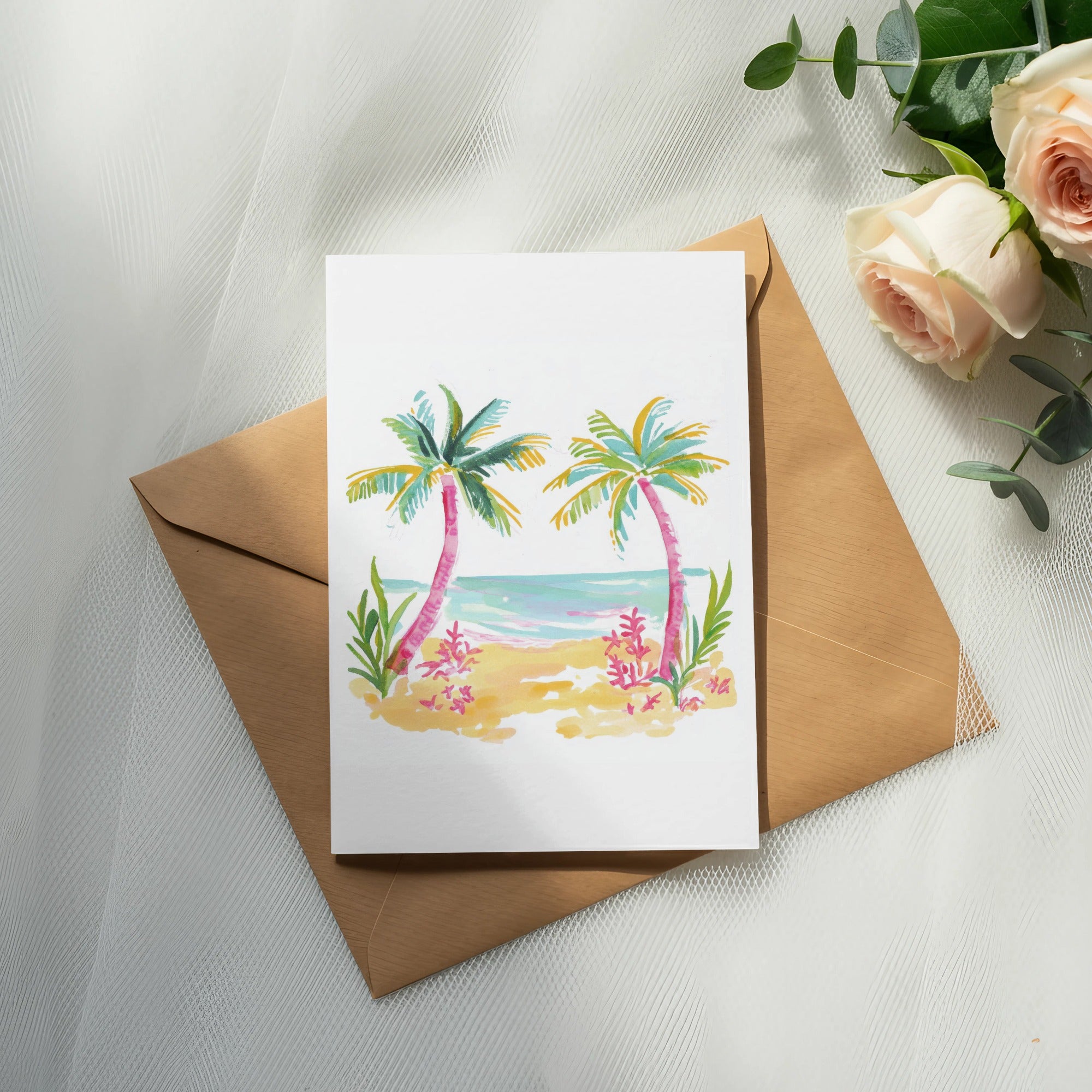 Watercolor beach scene with palm trees on a card atop a brown envelope.