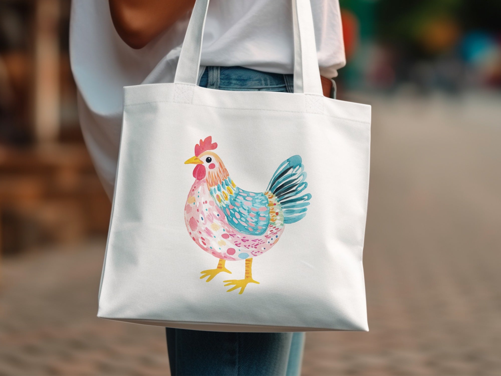 White tote bag with a watercolor illustration of a colorful rooster.