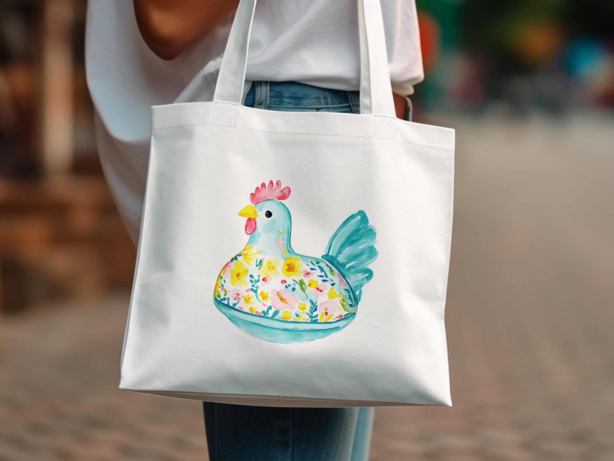White tote bag with a watercolor illustration of a chicken filled with flowers.