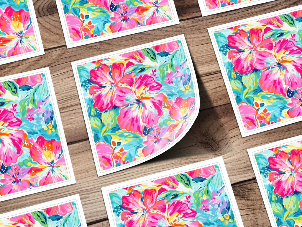 Floral hibiscus pattern on cards arranged on a wooden surface.