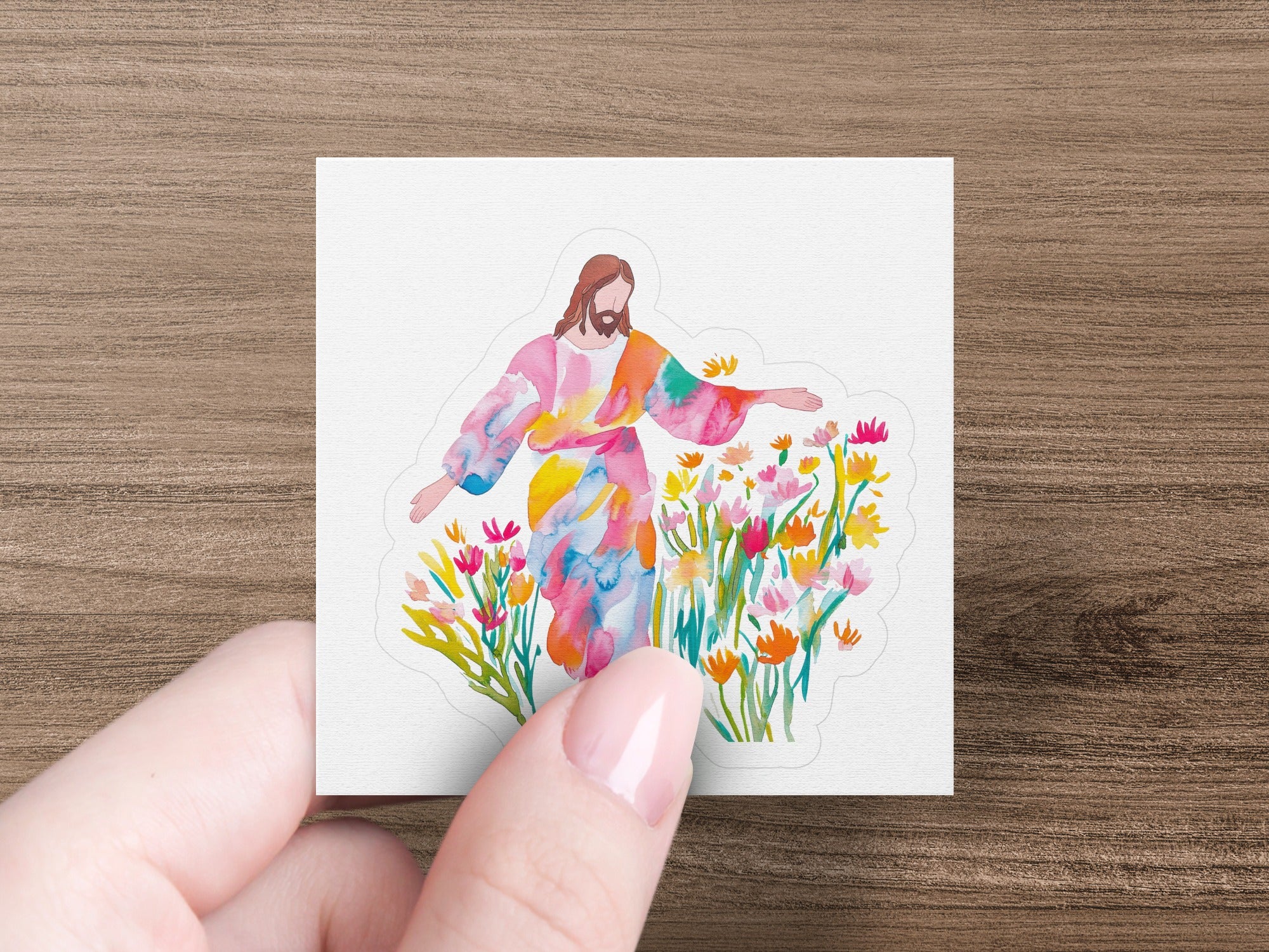 Jesus with outstretched arms surrounded by colorful flowers.