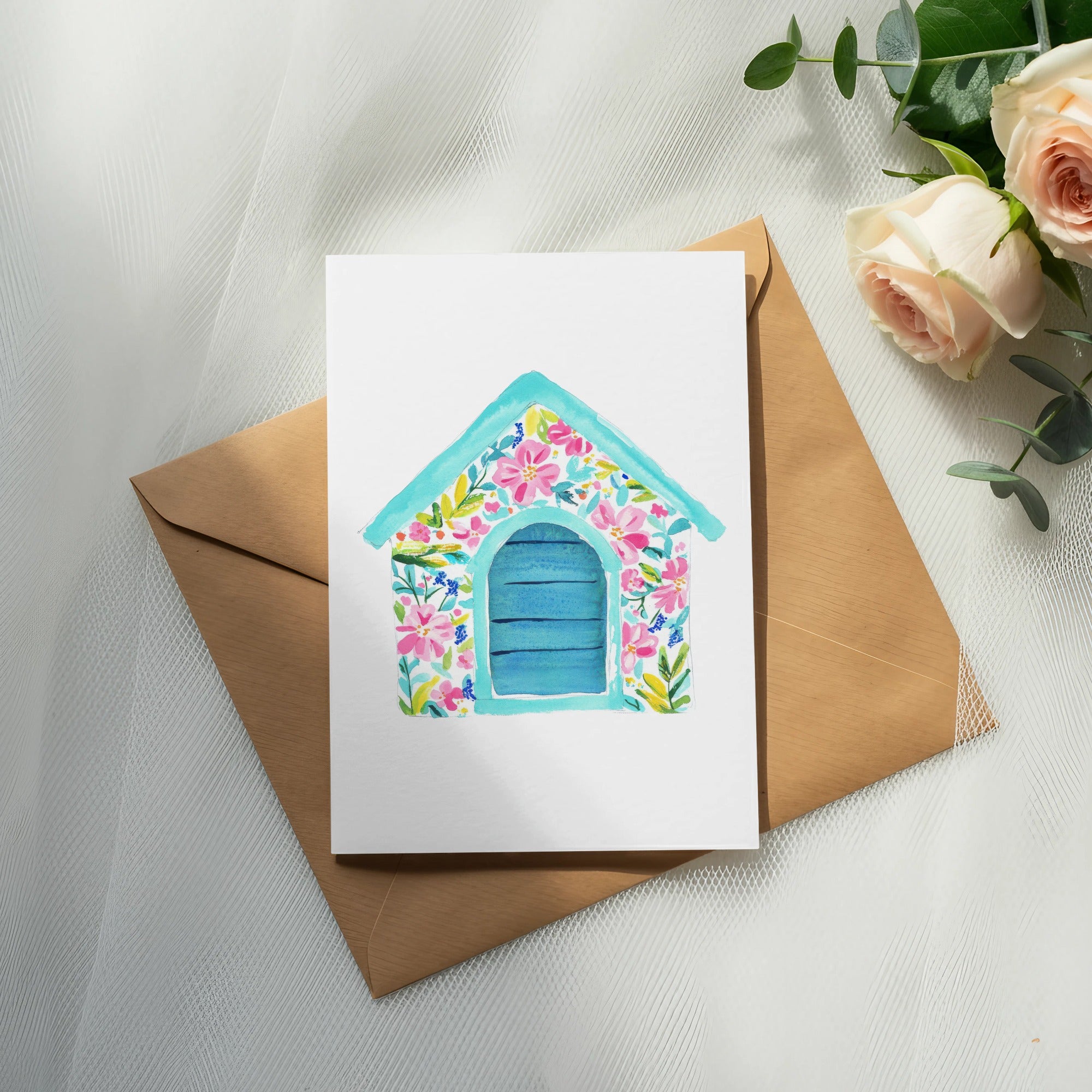 White card with blue door, decorated with pink flowers and green leaves.