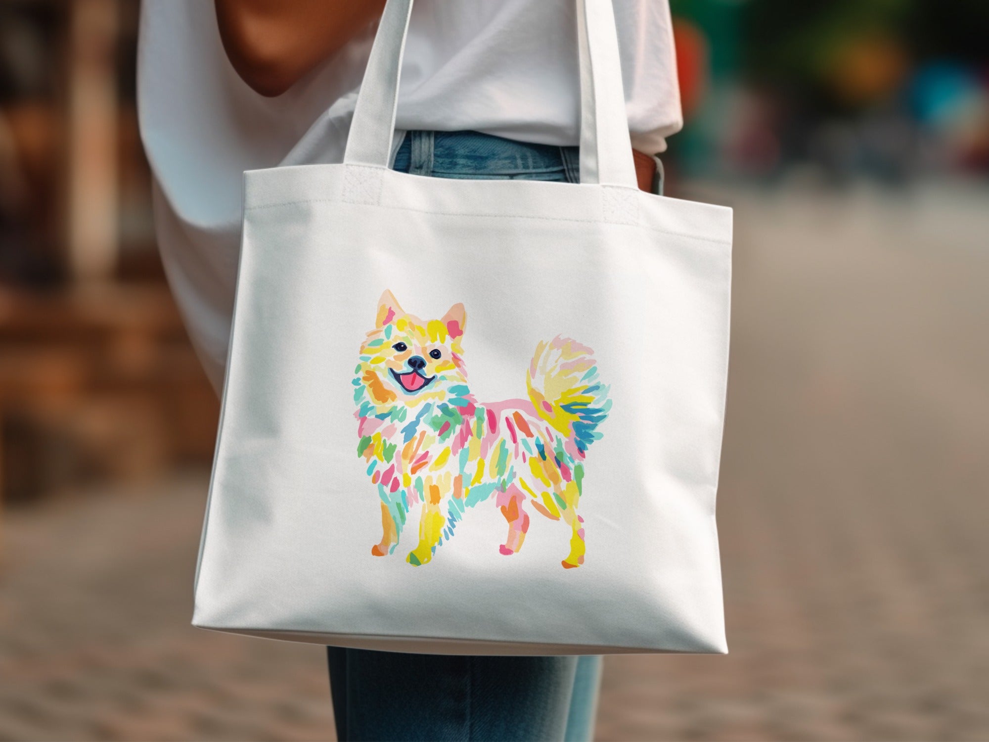 White tote bag with a colorful watercolor Pomeranian dog illustration.