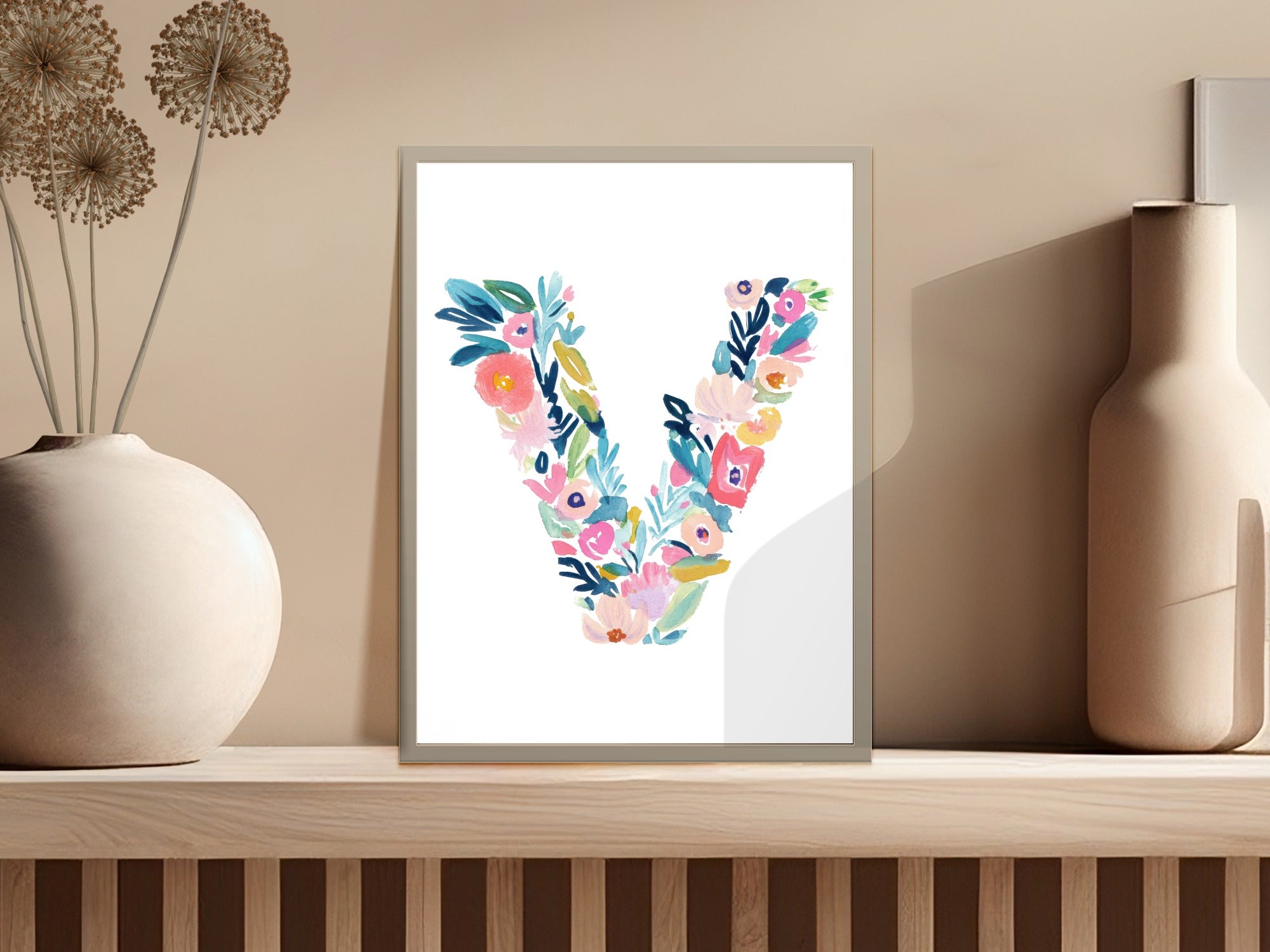 Watercolor floral letter V art print in a framed display.