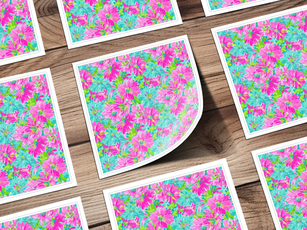 Floral patterned cards on a wooden surface, one corner peeling.