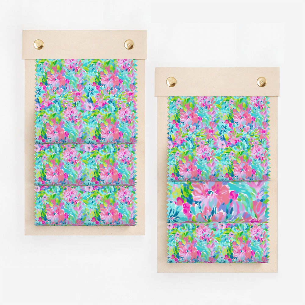 Floral fabric swatches in pink, blue, and green on display boards.