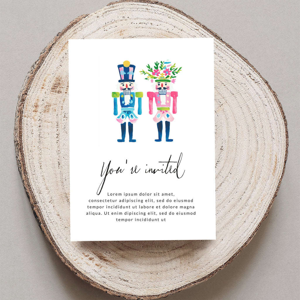 Nutcracker invitations with "You're invited" text on a wood slice.