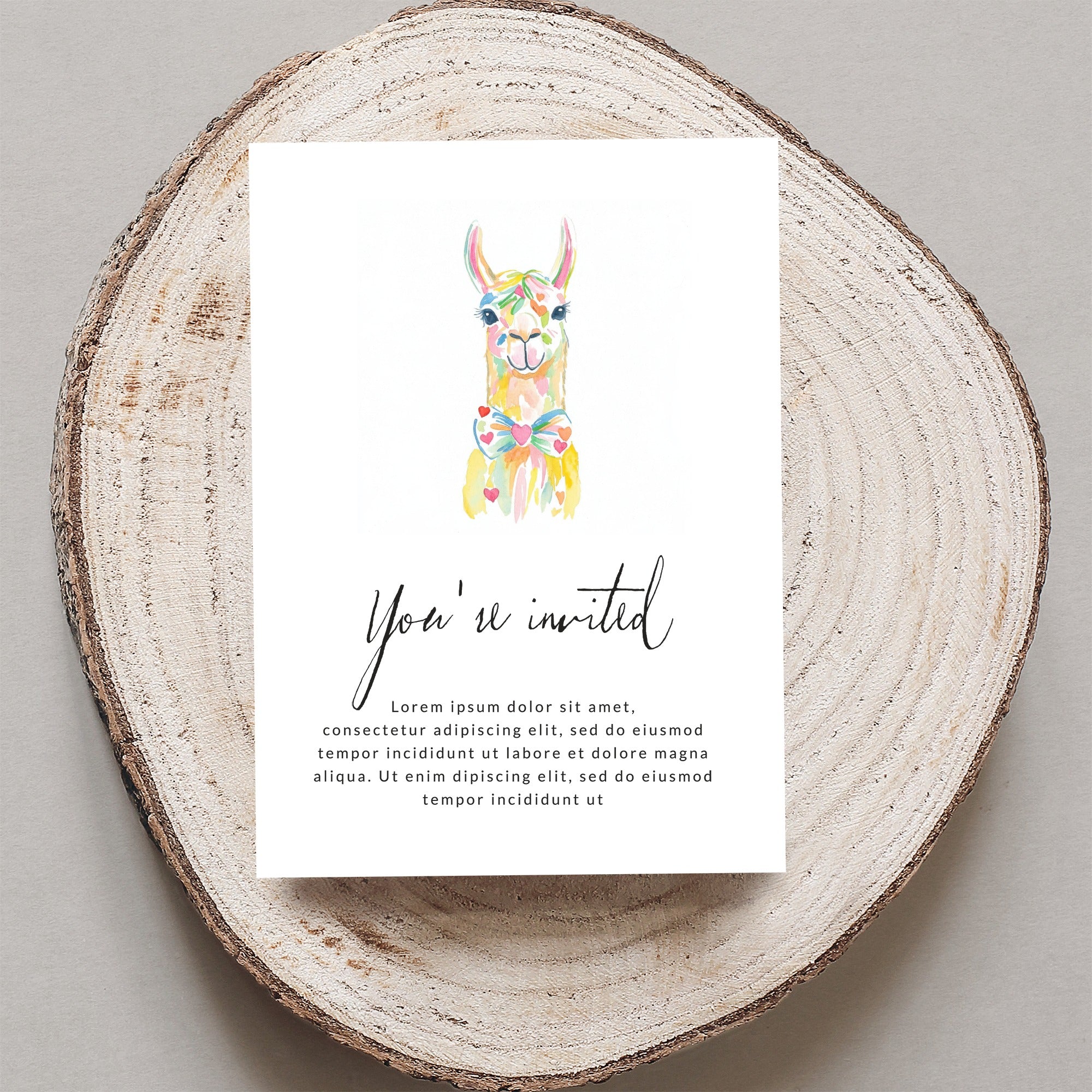 Colorful llama on invitation with "You're invited" text.