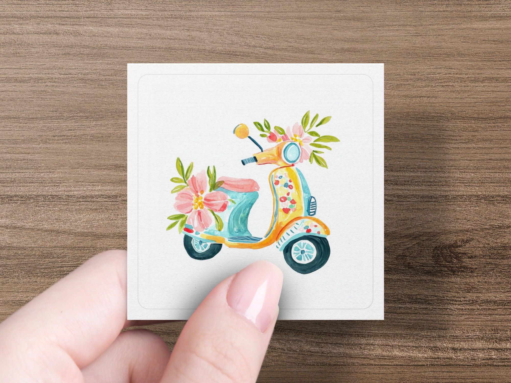 Watercolor illustration of a yellow and blue scooter with pink flowers.