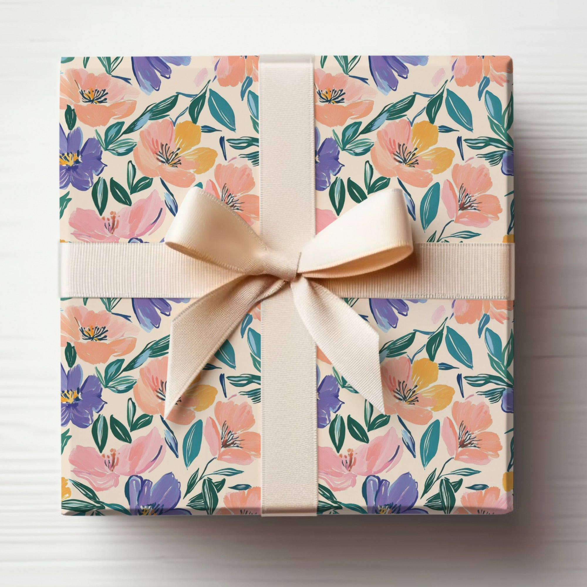 Gift box with a floral pattern and a light beige ribbon.