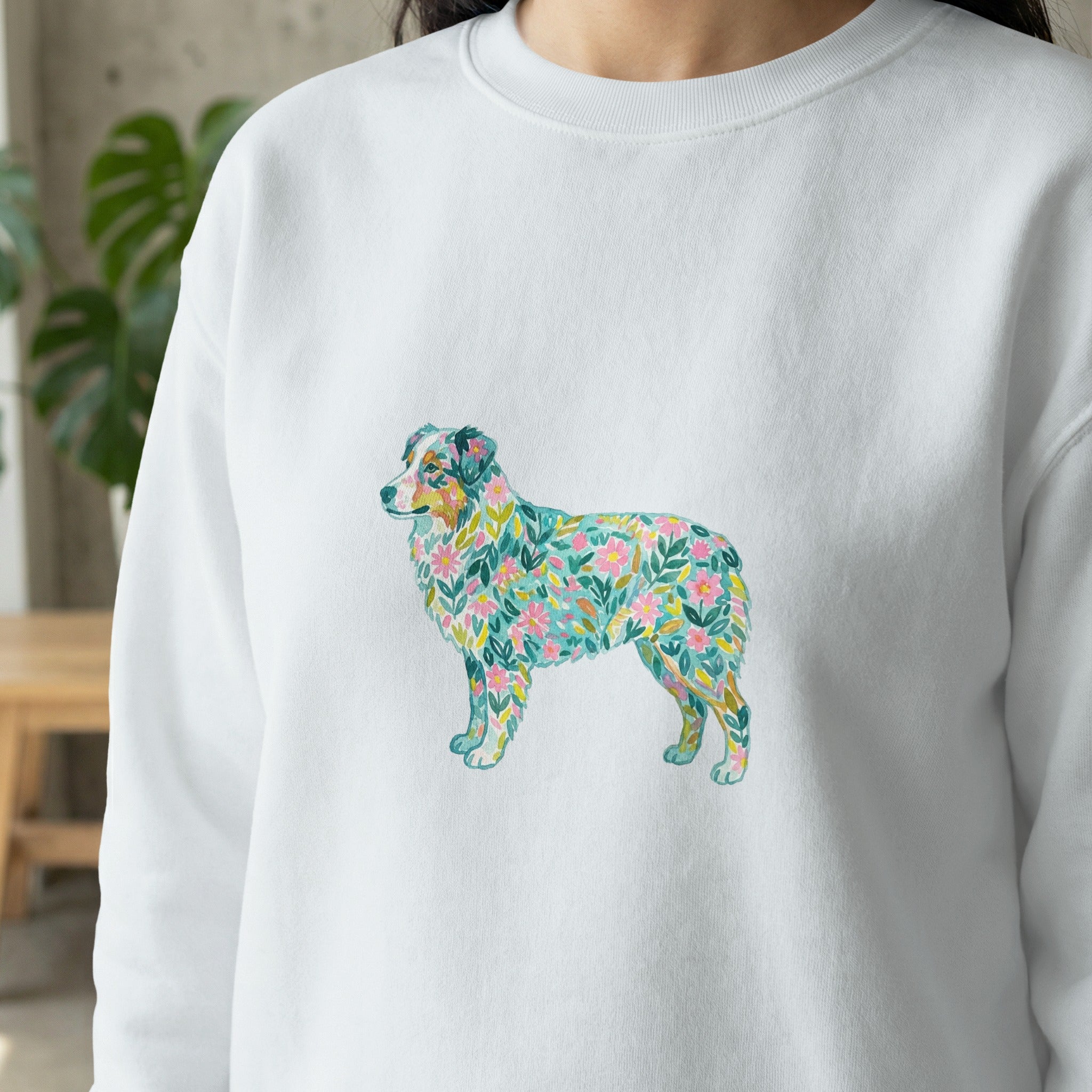White sweatshirt with a watercolor floral Australian Shepherd dog design.