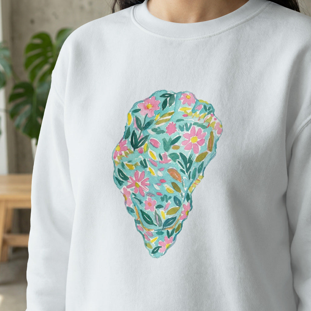 White sweatshirt with a colorful watercolor floral oyster shell design.