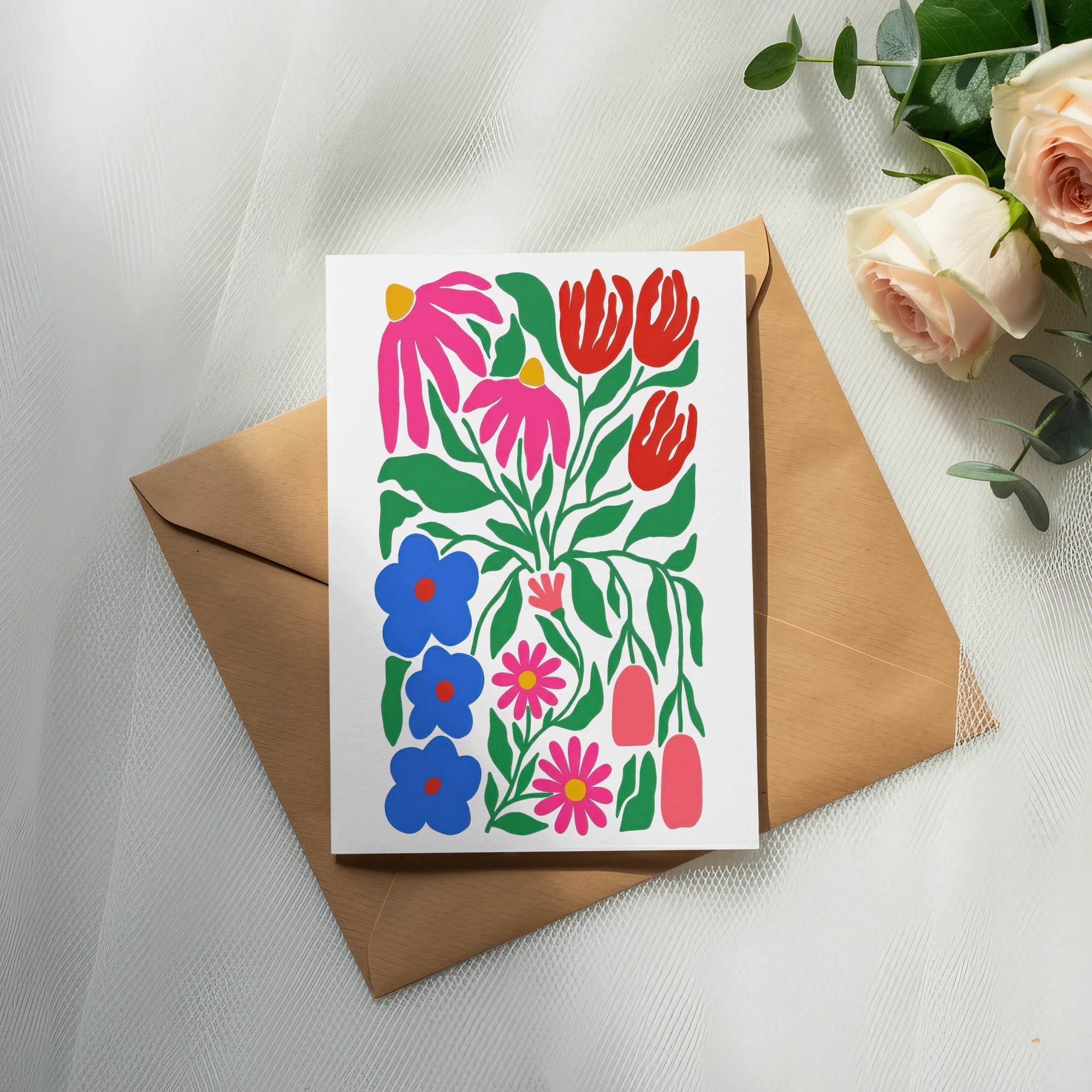 Colorful floral illustration on a card atop a brown envelope, with roses.