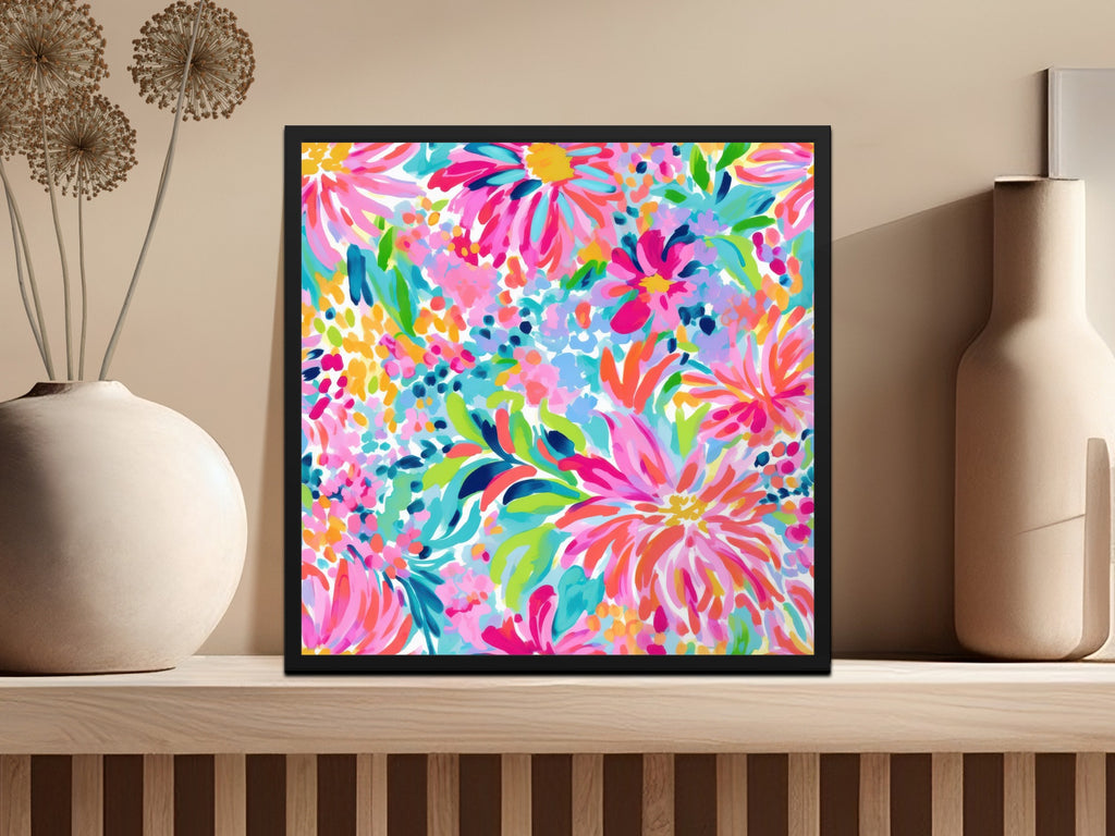 Black framed artwork featuring a vibrant, abstract floral painting in bright pinks, blues, and greens.