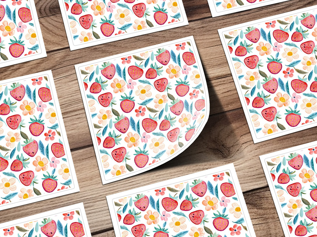 Scattered small cards with repeating strawberry and floral pattern.