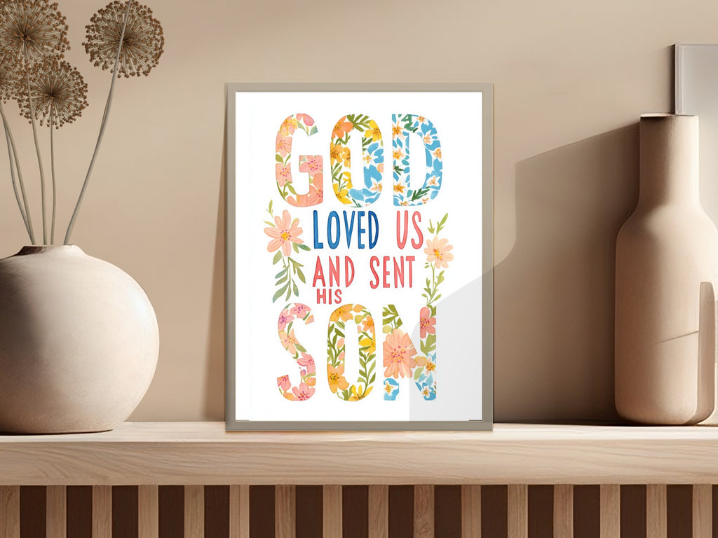"God loved us and sent his son" text art with floral accents.