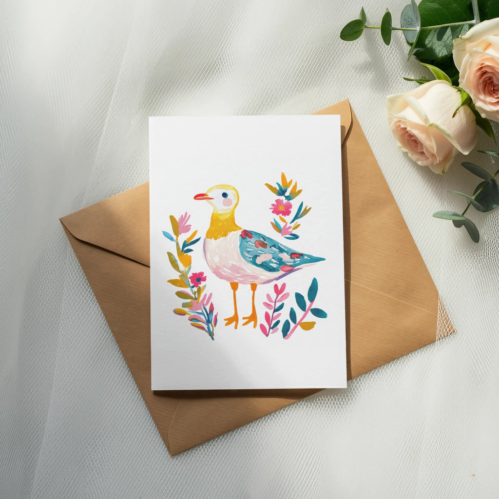 Watercolor painting of a bird with colorful flowers on a kraft envelope.