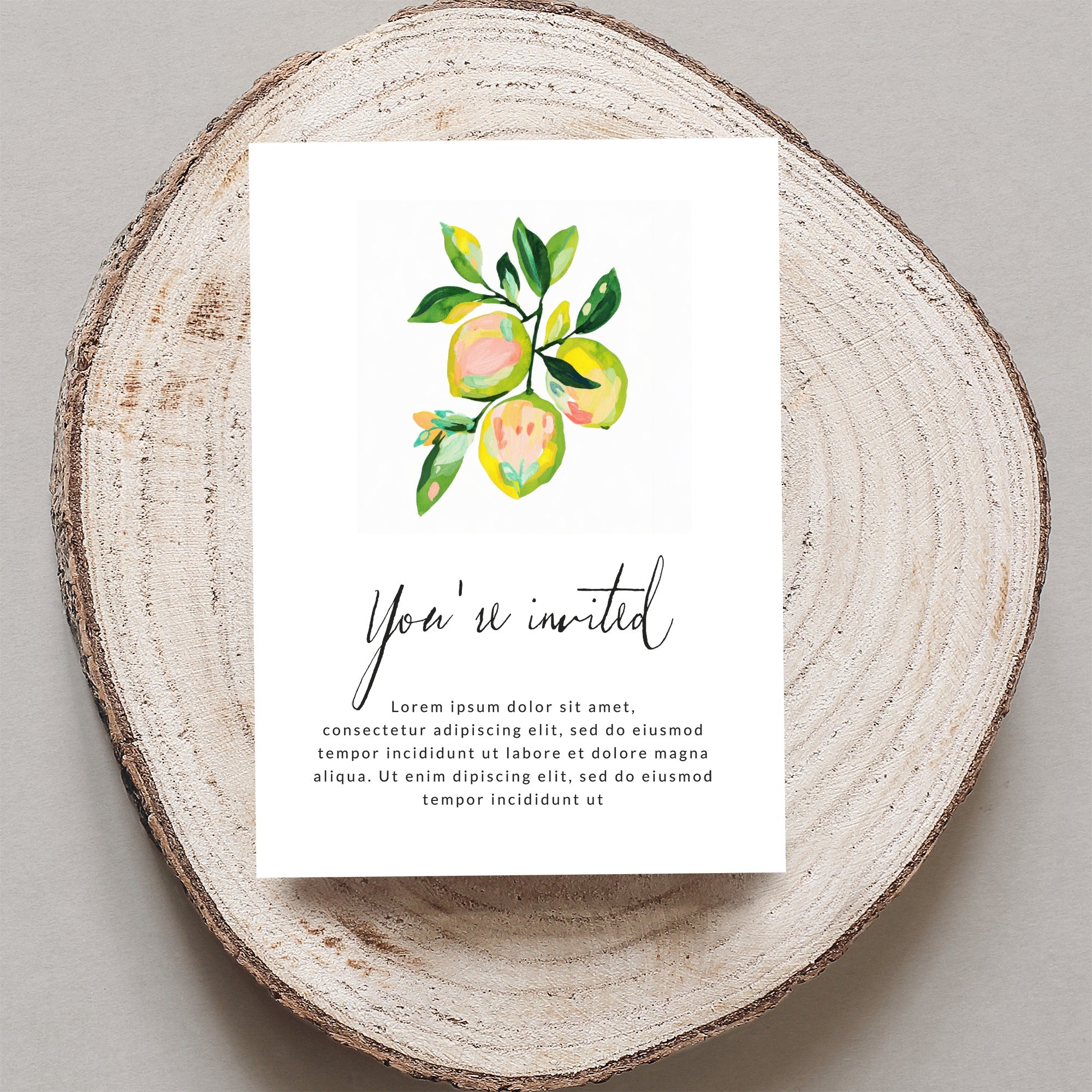 Invitation card with watercolor lemons and "You're invited" text.