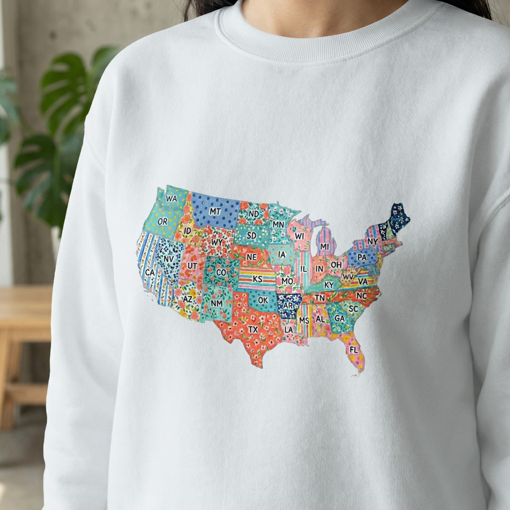 White sweatshirt with a colorful, patterned map of the United States.