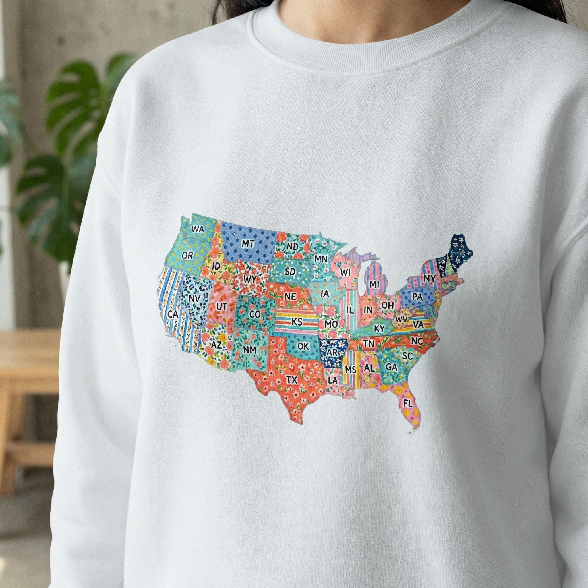 White sweatshirt with a colorful, patterned map of the United States.
