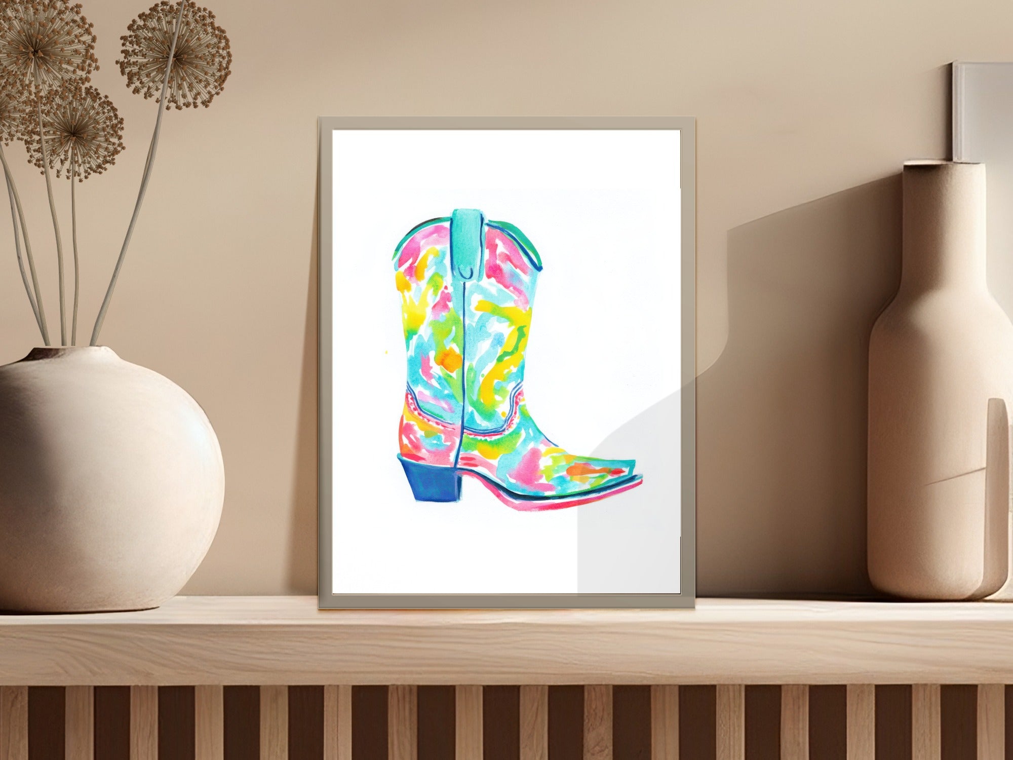 Colorful abstract watercolor cowboy boot art print in a white frame.