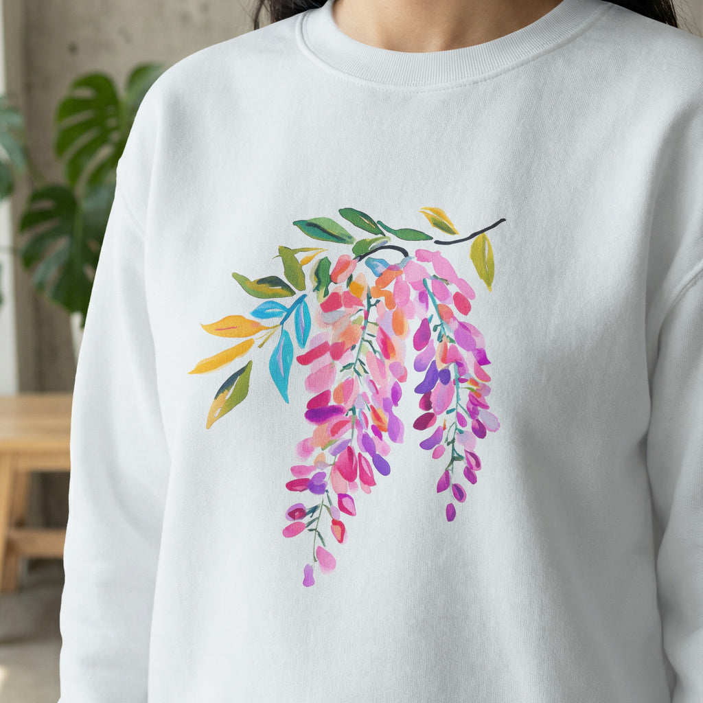 White sweatshirt with a watercolor illustration of pink and purple wisteria flowers.