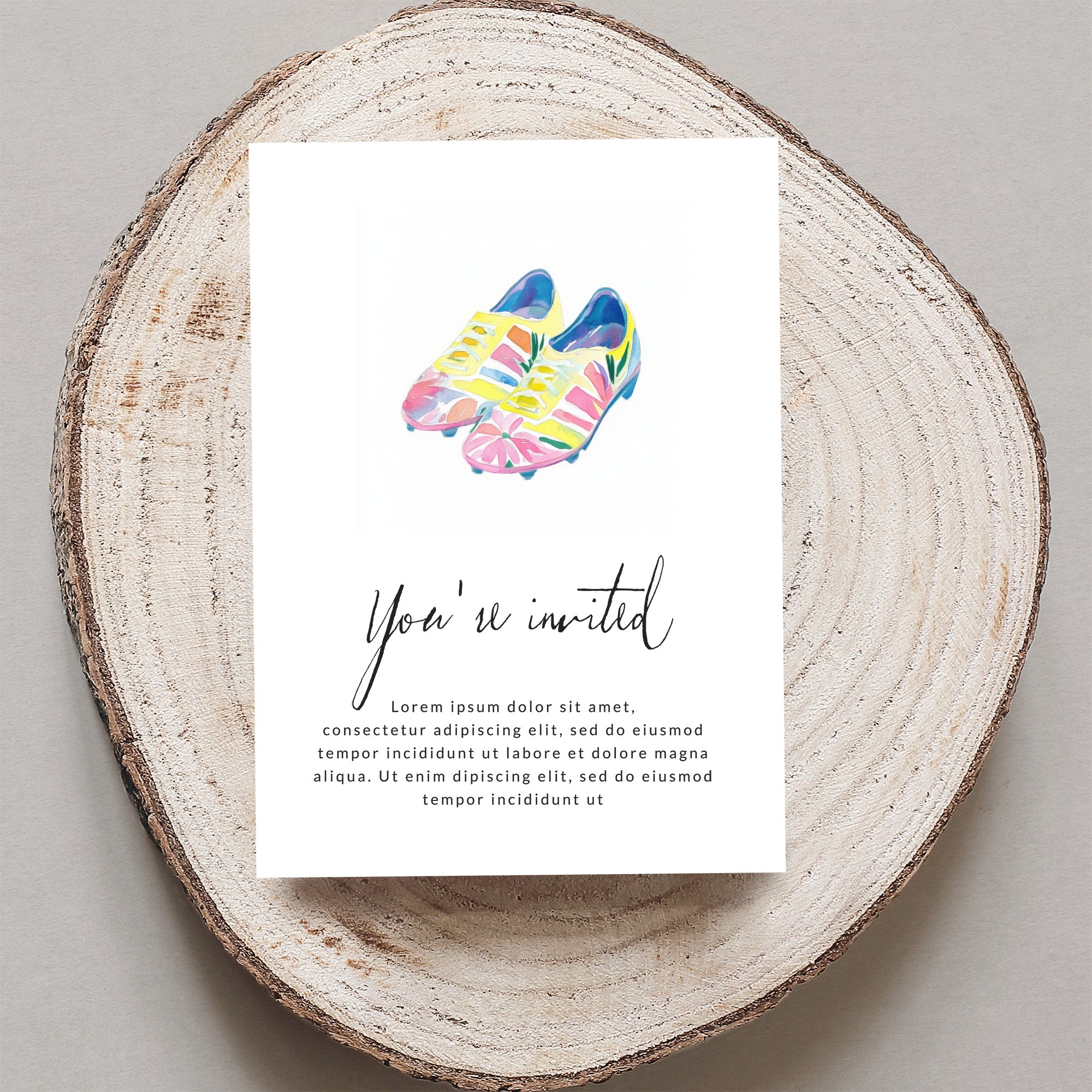 Watercolor invitation with soccer cleats and "You're invited" text.