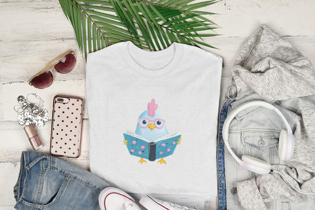 White t-shirt with cartoon chicken wearing glasses reading a book.