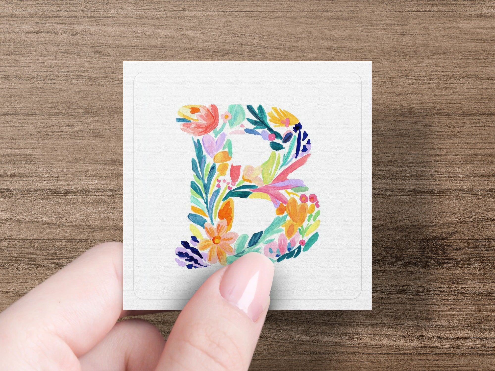 Floral letter B with colorful abstract flowers and leaves.