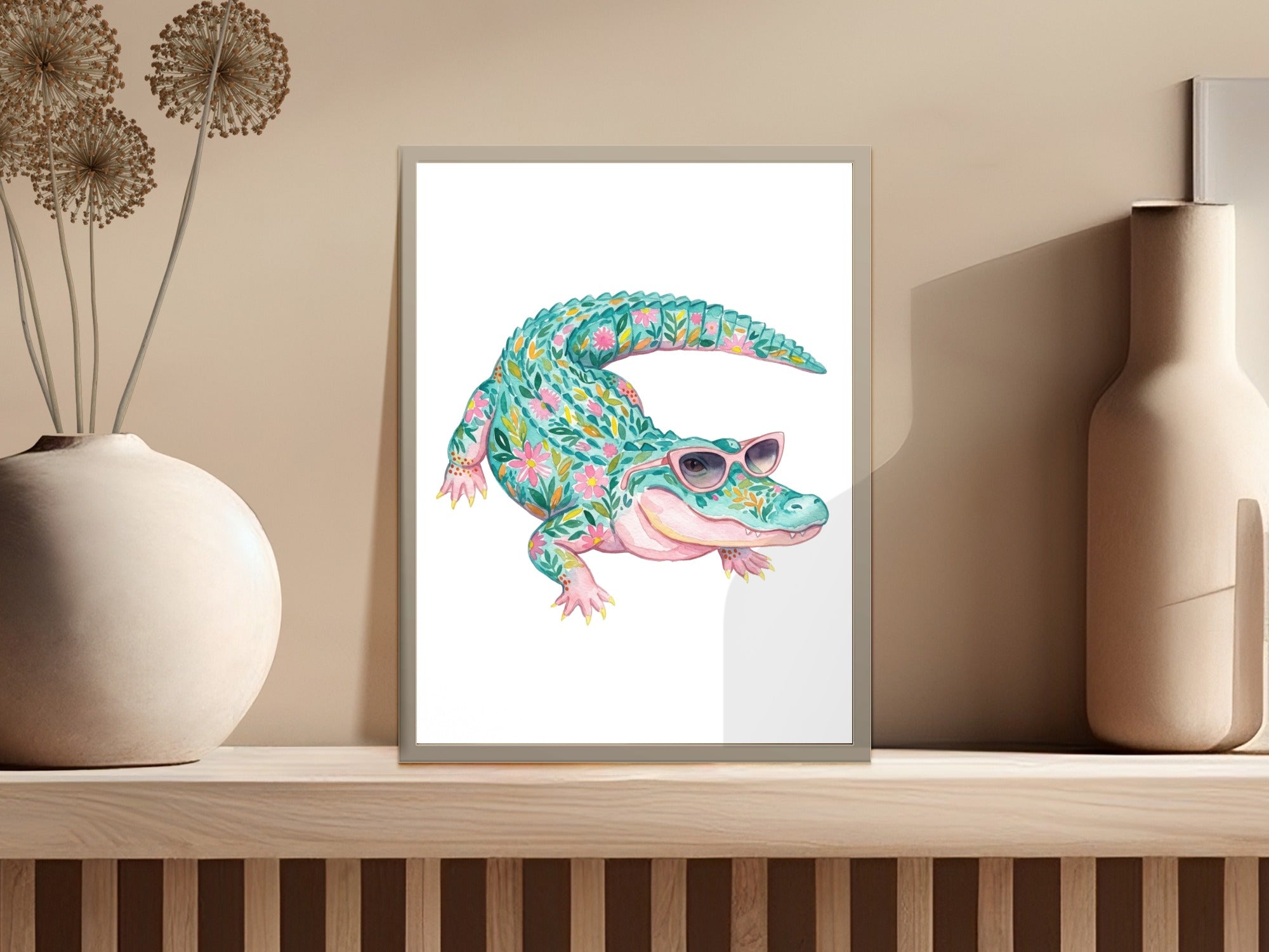 Alligator wearing pink sunglasses, surrounded by floral patterns, in a framed print.