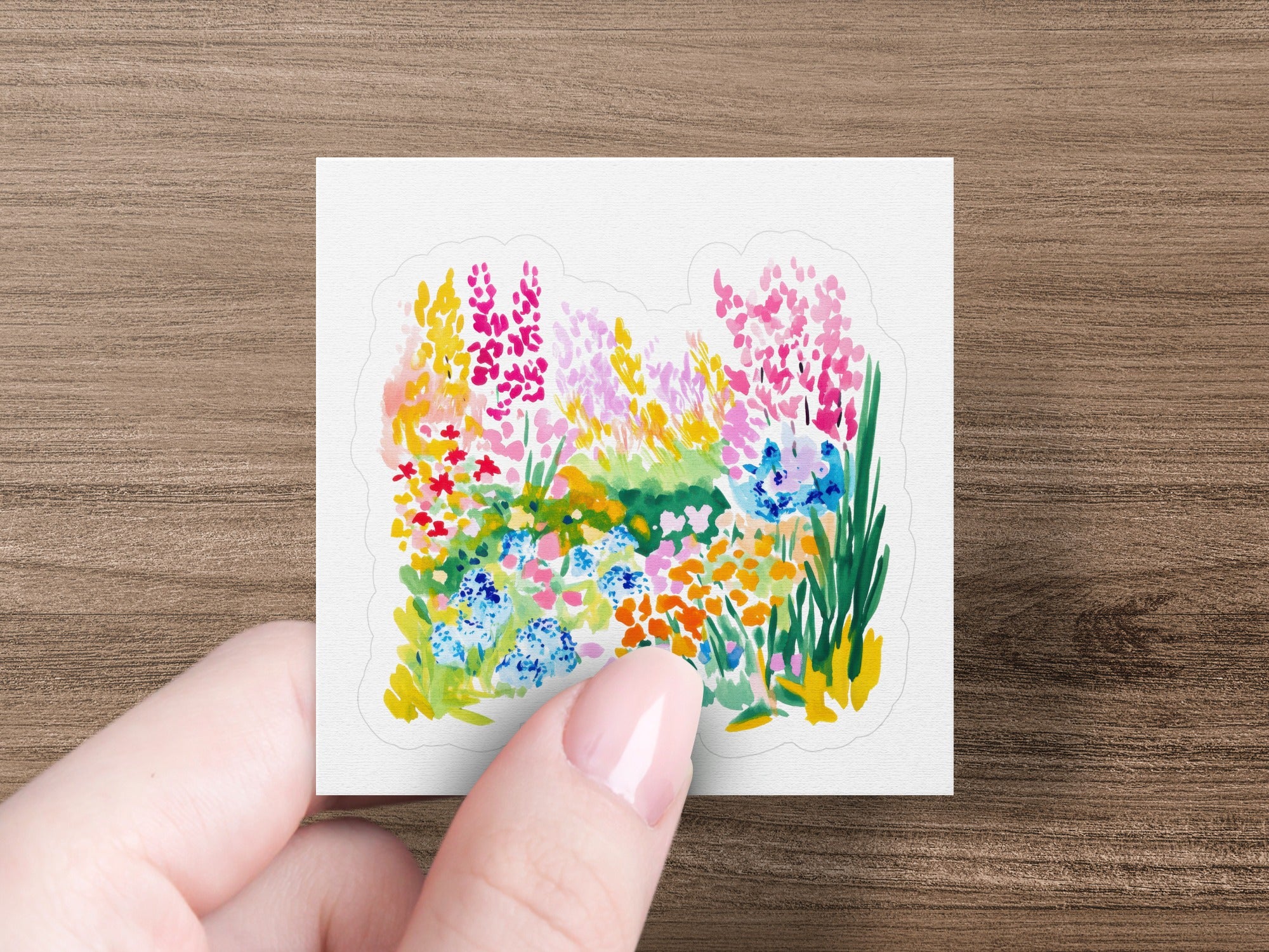 Watercolor floral illustration with pink, blue, and orange flowers.