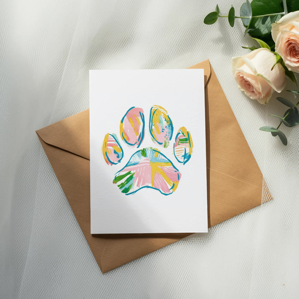 Card with colorful paw print design on brown envelope, with roses.