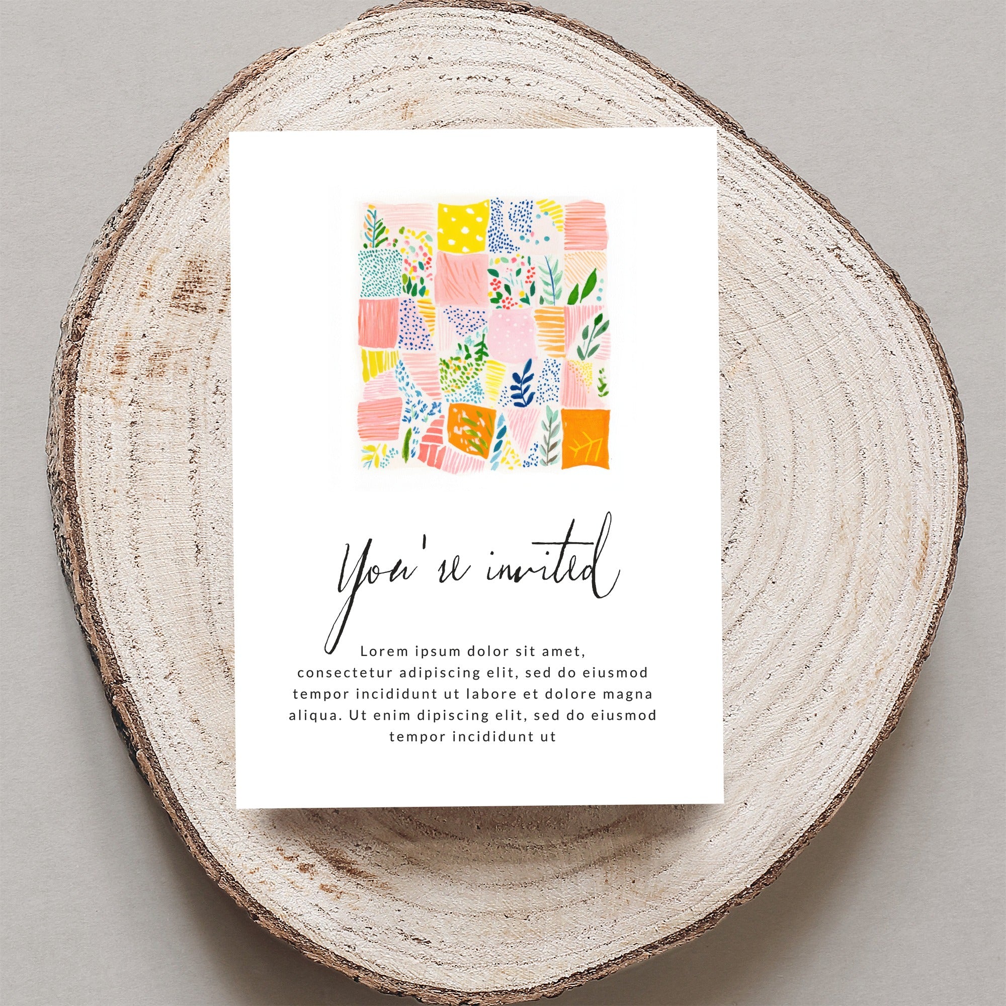 Invitation card with colorful patchwork design and "You're invited" text.