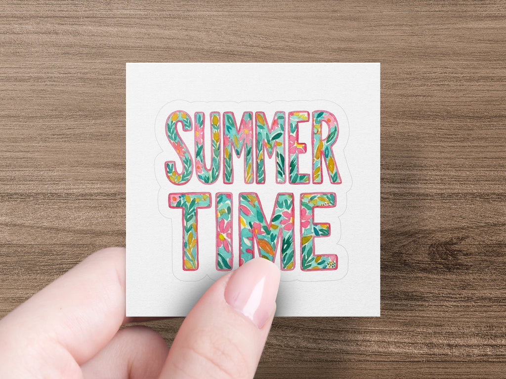 "SUMMER TIME" text with floral patterns, held by a person's hand.