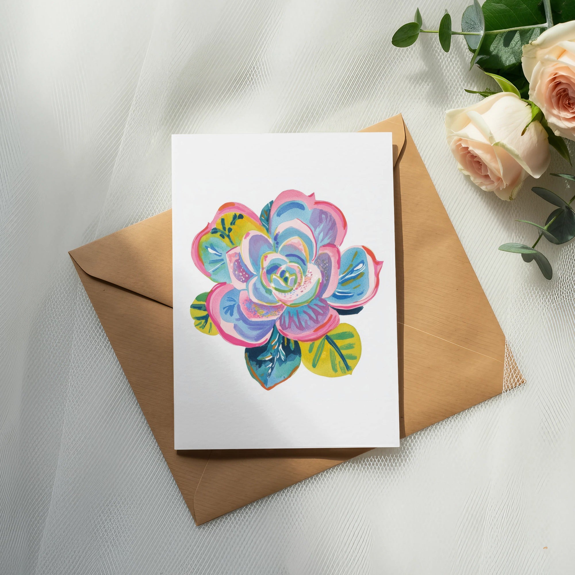 Greeting card with a colorful succulent illustration on a brown envelope.