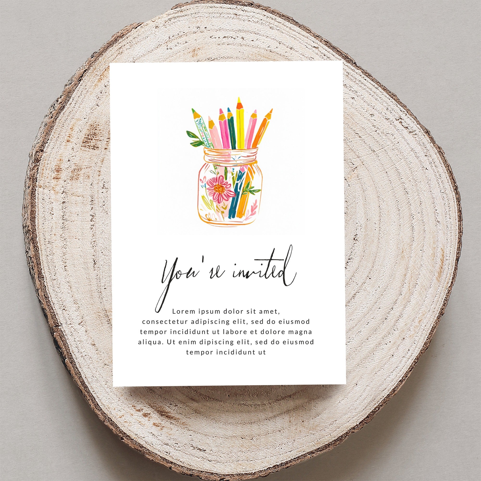 Invitation with colorful pencils in a jar and placeholder text.