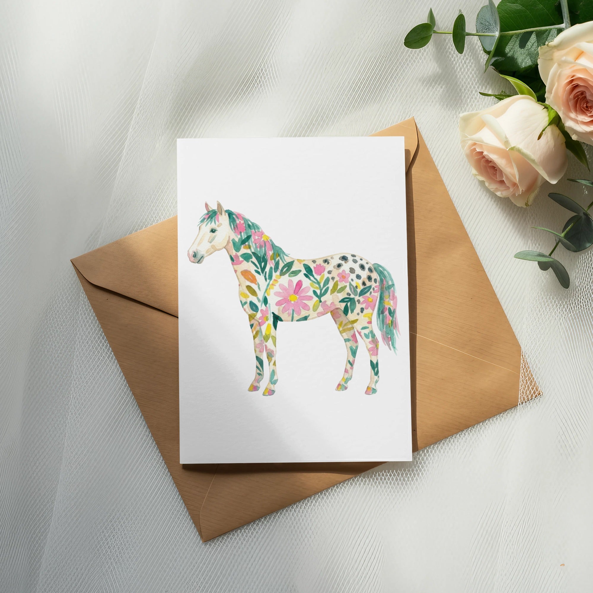 Card with a floral painted horse illustration on an envelope.