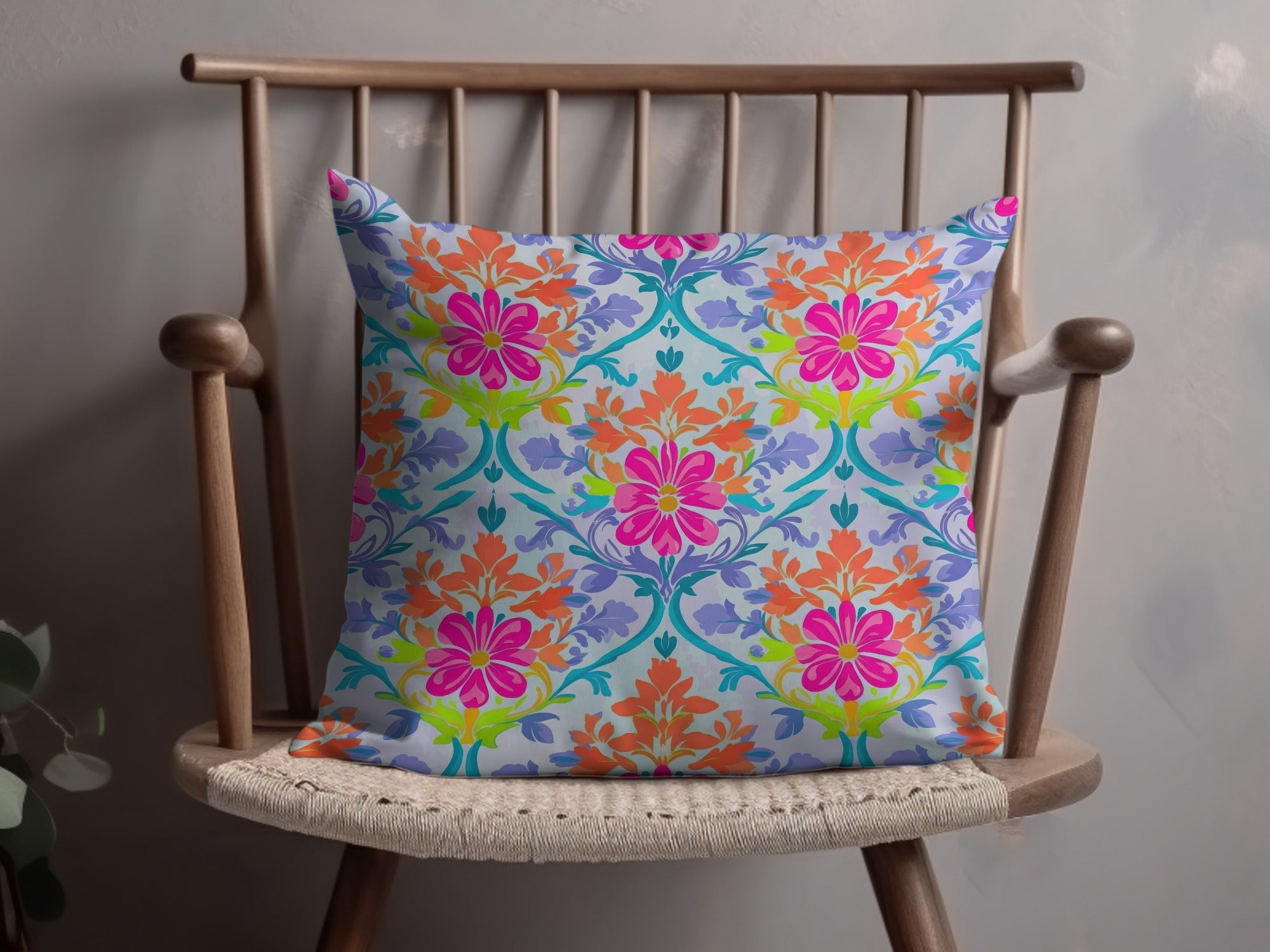 Decorative throw pillow with a vibrant floral pattern on a wooden chair.